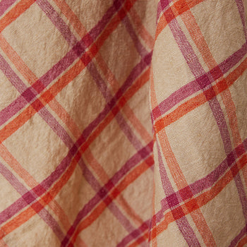 Close-up of the HKLIVING Vida Check Tea Towel in Strawberry/Cream, showing its soft, slightly textured linen-cotton blend with pink and orange checkered lines, gently draped.