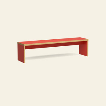 The HKLIVING Bench, 180cm by HKLIVING, features a minimalist rectangular shape with a red top and sides, exposed wooden edges, and a space-saving design, pictured against an off-white background.