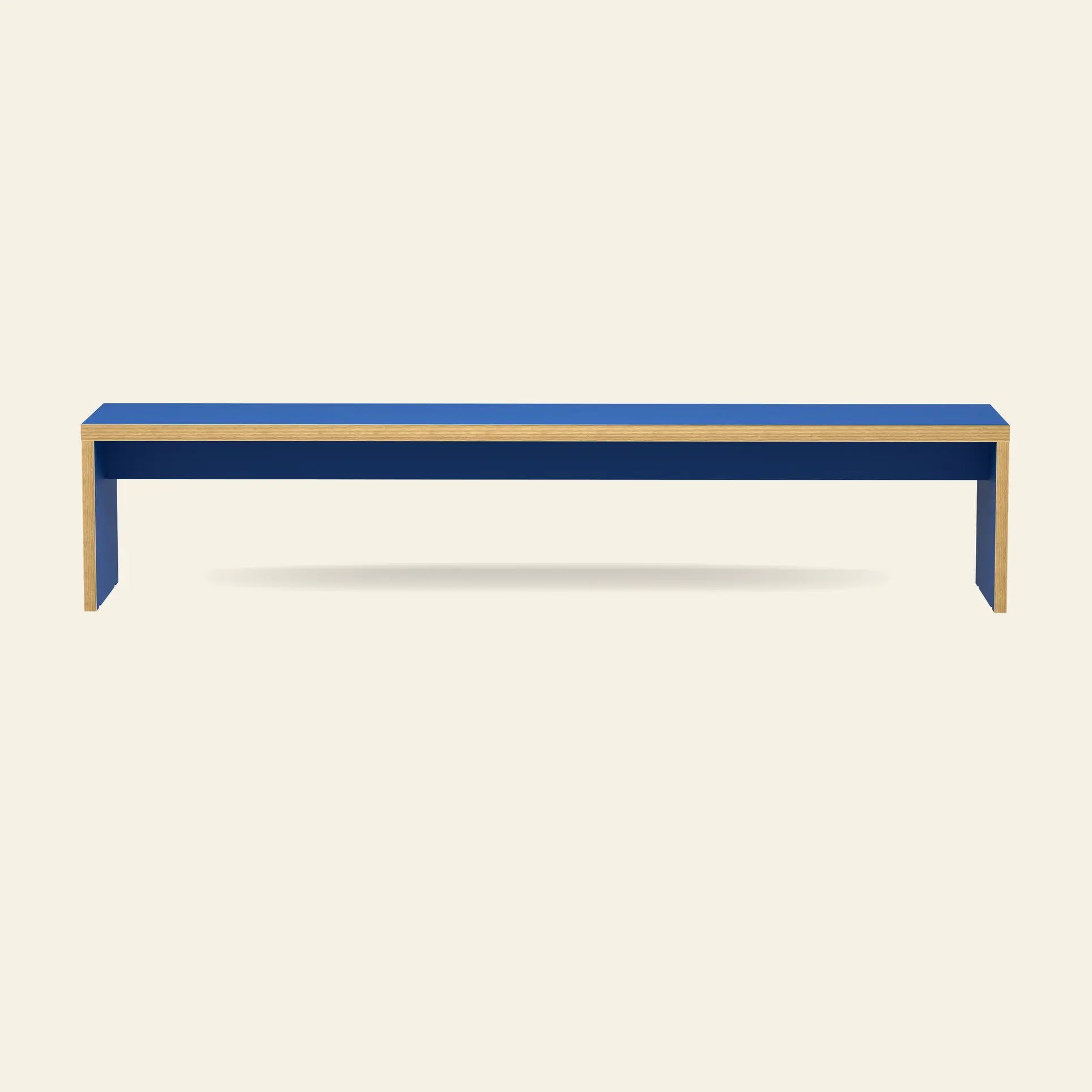 The HKLIVING Bench, 220cm, features a minimalist blue design with light wood edges and is showcased against a plain beige background.