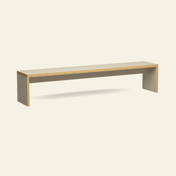 The HKLIVING Bench, 220cm by HKLIVING is a minimalist wooden dining bench featuring a rectangular seat, straight legs, and a light wood finish. Shown against an off-white background, it offers space-saving seating for a modern look.