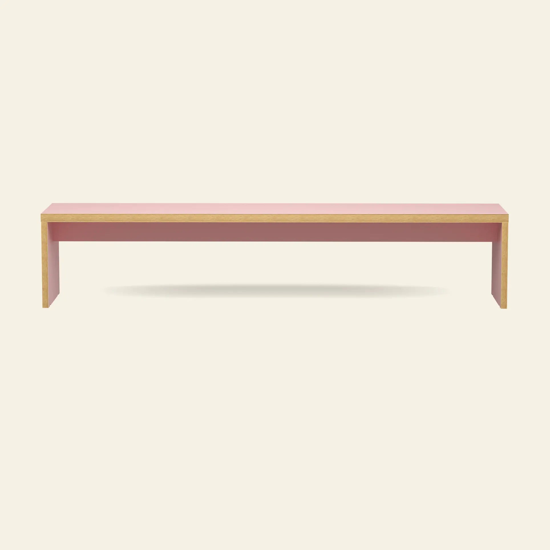The HKLIVING Bench, 220cm by HKLIVING features a minimalist rectangular design with a pink top and legs, natural wood edges, and space-saving seating—all set against a plain light background.