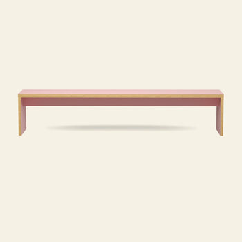 The HKLIVING Bench, 220cm by HKLIVING features a minimalist rectangular design with a pink top and legs, natural wood edges, and space-saving seating—all set against a plain light background.