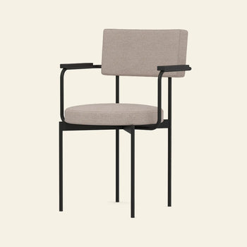 The HKLIVING Dining Armchair, Main Line Flax, Black features a sleek black metal frame, beige cushioned seat and backrest, stackable design with armrests, and showcases Dutch design by HKLIVING against a plain light background.