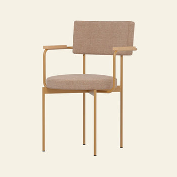 The HKLIVING Dining Armchair, Main Line Flax in Dusty by HKLIVING features a modern Dutch design with a light brown upholstered seat and backrest, thin gold metal legs and armrests, set against a plain beige background.
