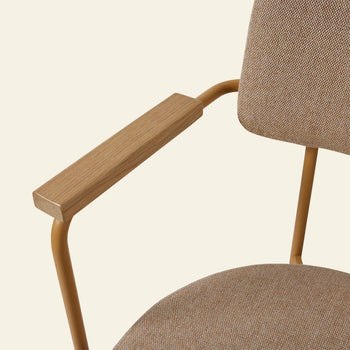 Close-up of the HKLIVING Dining Armchair in Main Line Flax Dusty, featuring a tan fabric seat and backrest, wooden armrests, and a metal frame, by HKLIVING, set against a light beige background.