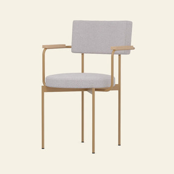 The HKLIVING Dining Armchair, Yoredale, Dusty by HKLIVING is a Dutch-inspired armchair featuring a light beige cushioned seat and backrest with thin armrests and legs on a tan minimalist metal frame for a contemporary look.