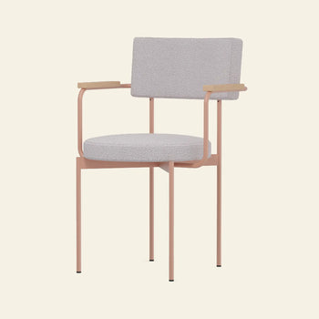 The HKLIVING Dining Armchair Yoredale Nude features a modern Dutch design with a light gray cushioned seat and backrest, slim pink metal legs and frame, and light wooden armrests, shown against a plain beige background.
