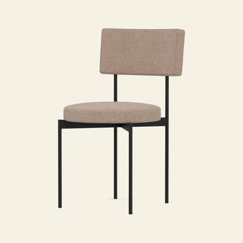 The HKLIVING Dining Chair, Main Line Flax, Black by HKLIVING features a modern design with a round upholstered beige seat, rectangular backrest, and minimalist black metal frame with four straight legs.