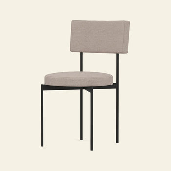 The HKLIVING Dining Chair, Main Line Flax in Black, features a beige upholstered seat and backrest, slim black metal legs and frame, and a Dutch-inspired modern design, displayed against a plain light background.