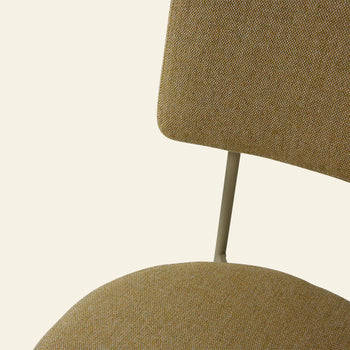 Close-up view of the HKLIVING Dining Chair, Main Line Flax in Olive, showcasing its textured green fabric seat and backrest on a slim, light metal frame against a beige background.
