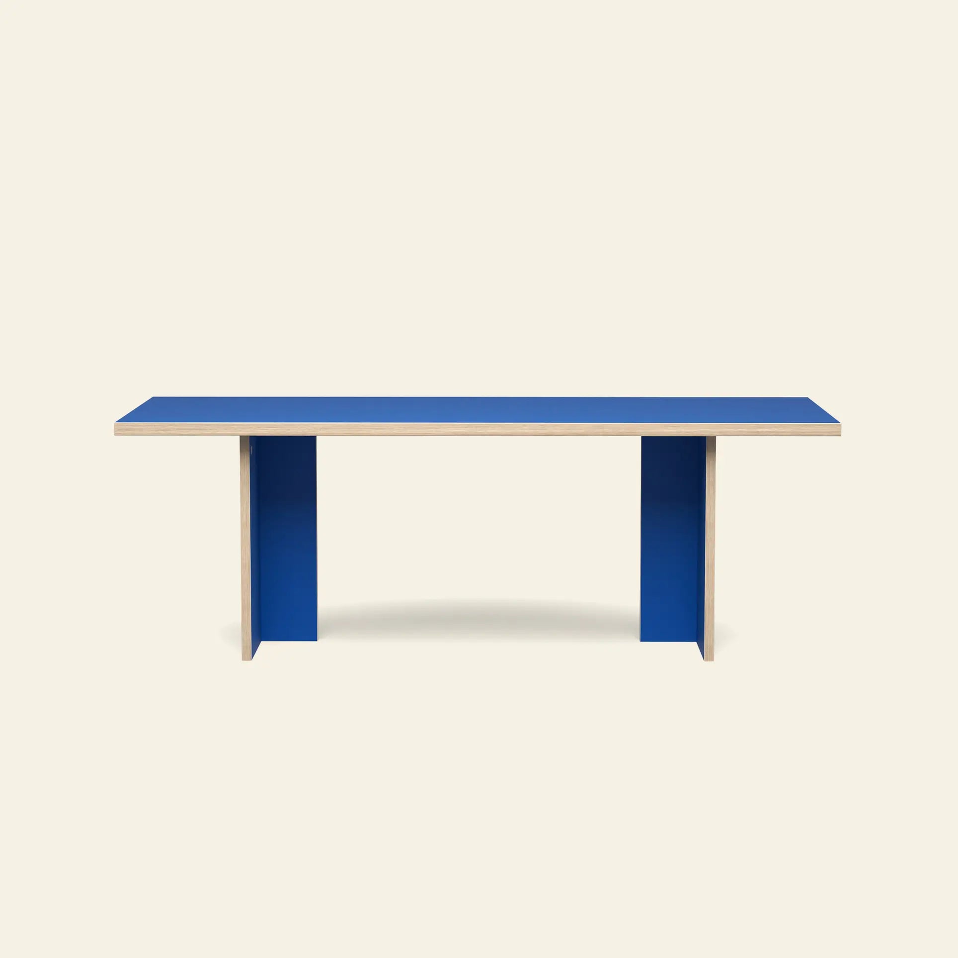 The HKLIVING Dining Table, Rectangular, 220cm by HKLIVING features a minimalist blue tabletop and two wide blue legs, shown against a plain beige background.