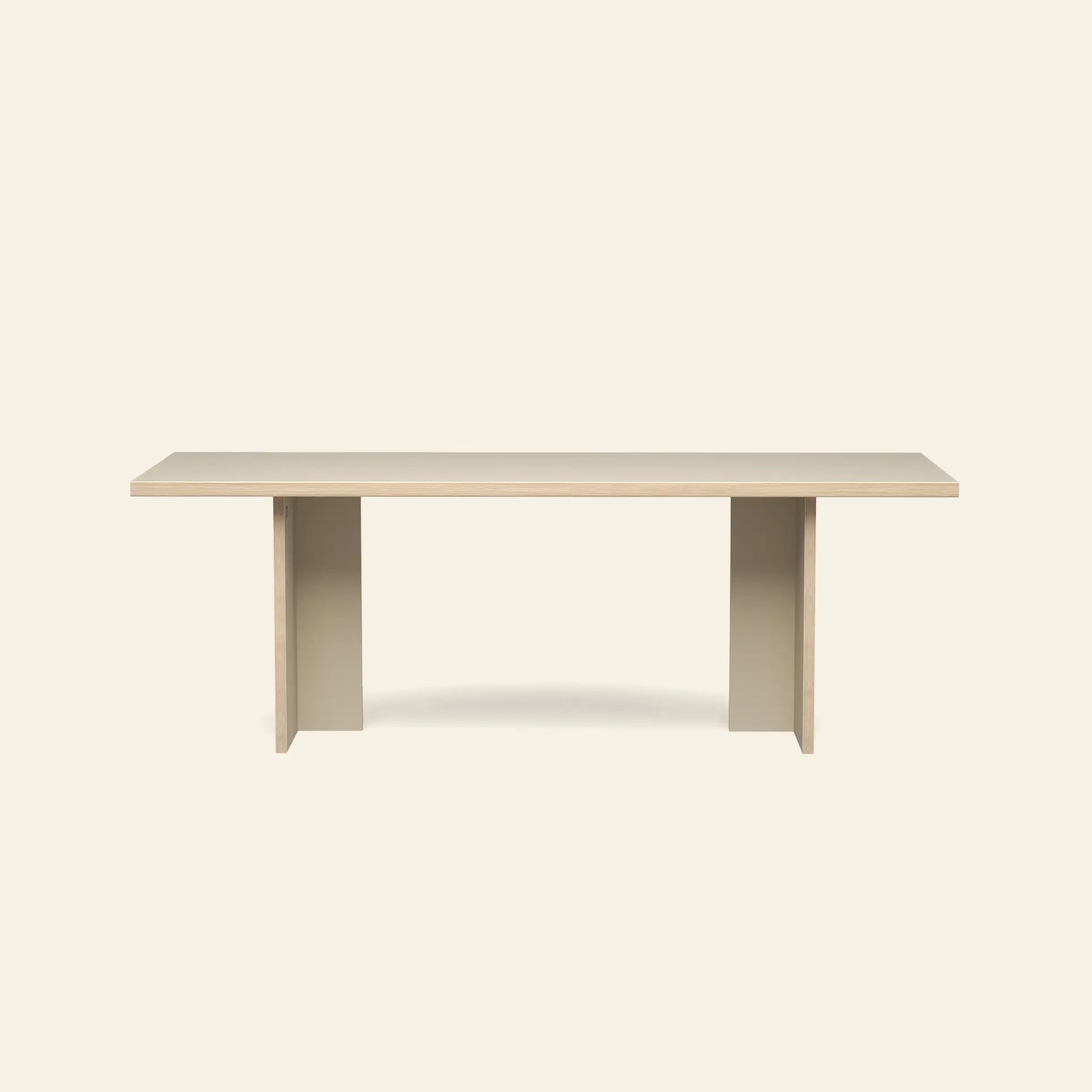 The HKLIVING Dining Table, Rectangular, 220cm, features a light wood top and two solid beige legs for a minimalist look. By HKLIVING, this elegant table offers ample space and fits beautifully in modern, understated dining rooms.
