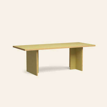 The HKLIVING Dining Table, Rectangular, 220cm features a modern design with a light yellow top and thick flat panel legs, displayed against an off-white background.
