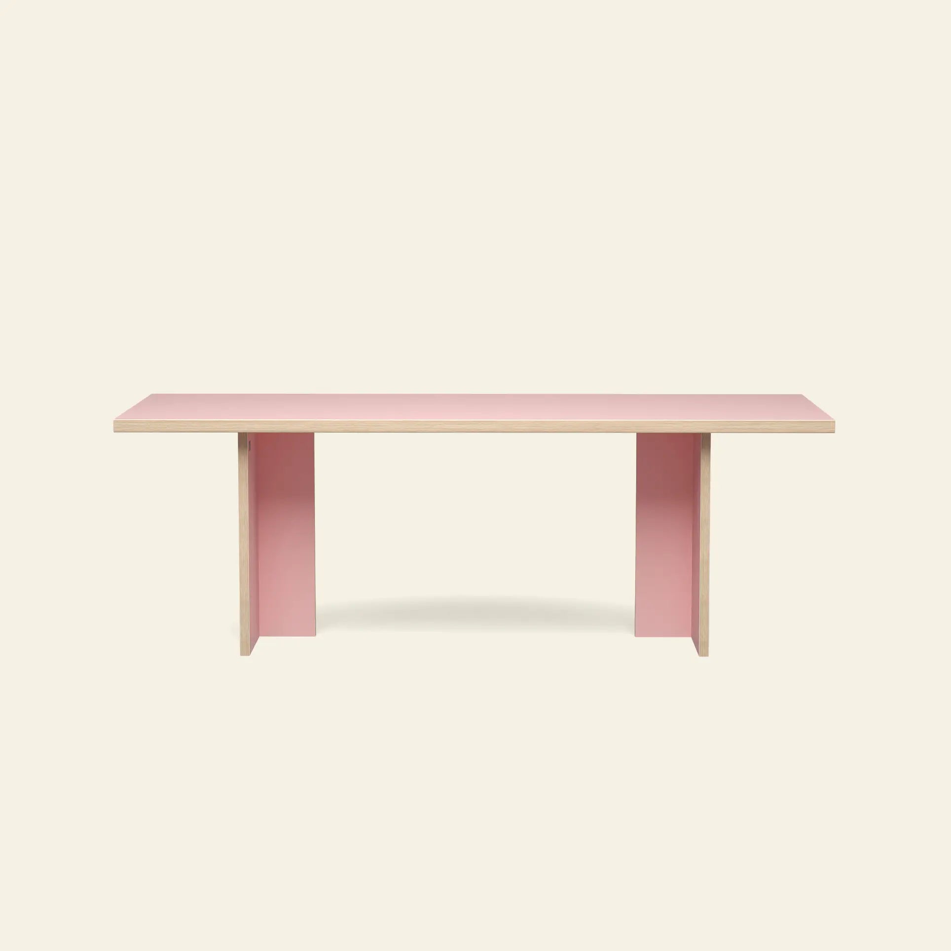 The HKLIVING Dining Table, Rectangular, 220cm, features a minimalist light pink top and legs with natural wood edges, set against a plain beige background.