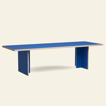 The HKLIVING Dining Table, Rectangular, 280cm by HKLIVING features a bright blue surface, matching panel legs, visible light wood edges, and clean minimalist lines for a timeless look against a plain light background.