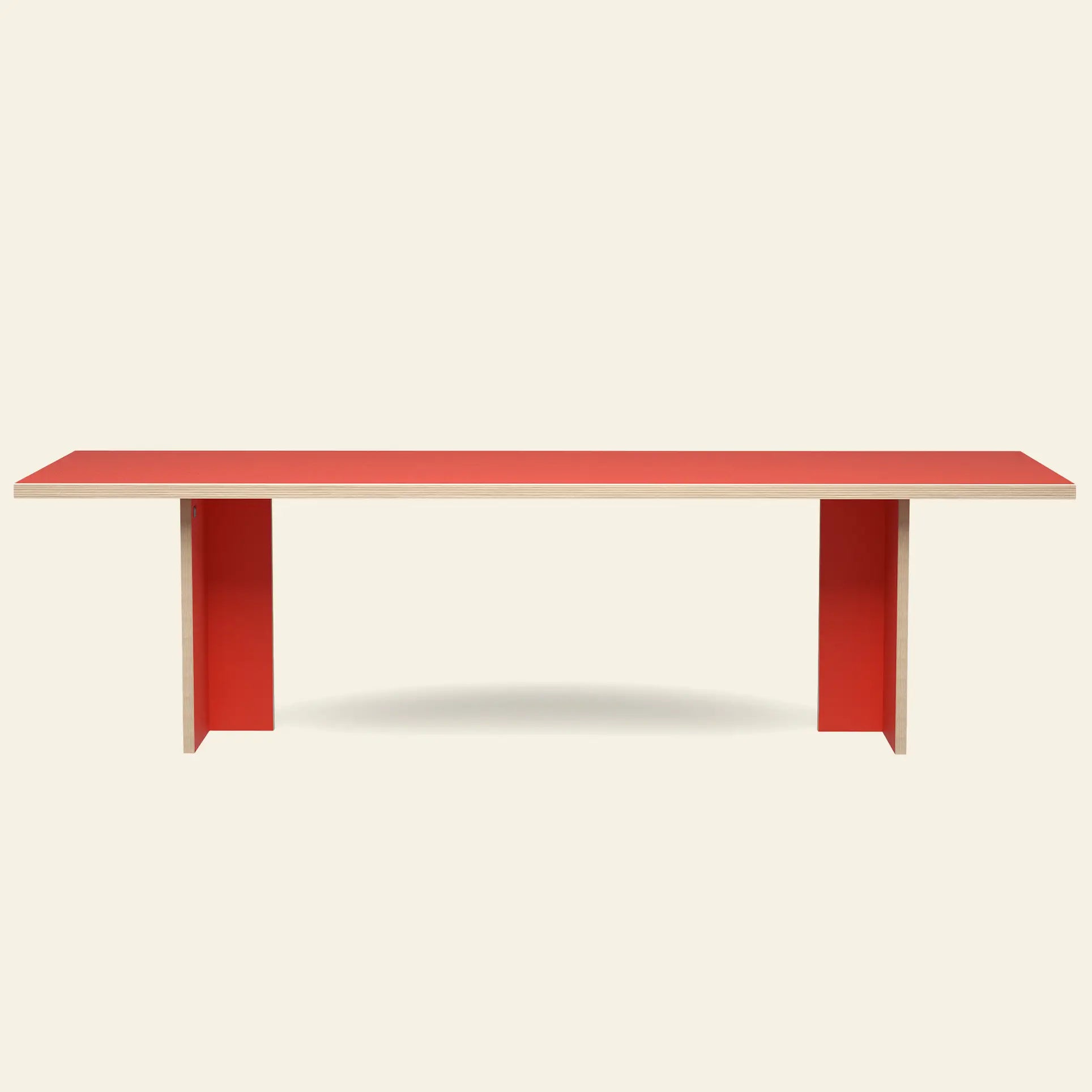 The HKLIVING Dining Table, Rectangular 280cm by HKLIVING features a minimalist red top and two wide red legs. Photographed against a plain light background, it reflects the brand’s timeless design aesthetic.