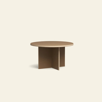 The HKLIVING Dining Table is a round, 130cm light brown wooden table featuring a thick tabletop and unique intersecting X-shaped base, showcased against a plain off-white background.