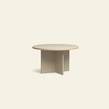 The HKLIVING Dining Table is a round, 130cm light beige table with a smooth top and intersecting flat panel legs, shown against an off-white background.