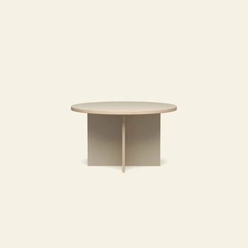 The HKLIVING Dining Table, Round, 130cm, features a minimalist light wood design with a simple cross-shaped base and is presented against an off-white background.