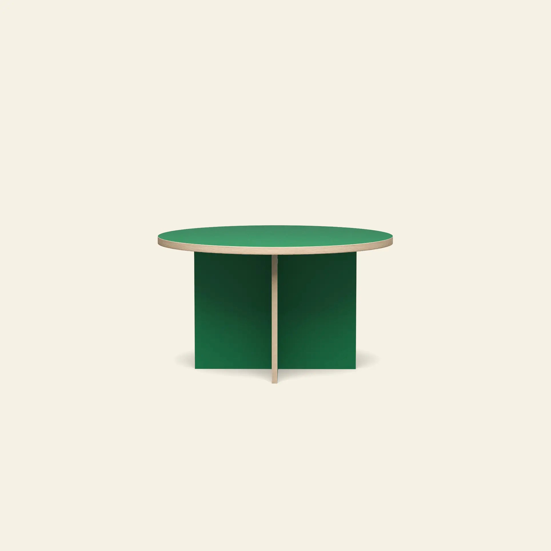 The HKLIVING Dining Table, Round, 130cm by HKLIVING features a minimalist design with a light wood edge and intersecting green panel legs, shown against a plain off-white background.