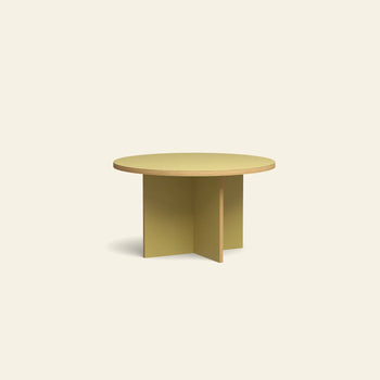 The HKLIVING Dining Table, Round, 130cm, features a light yellow finish and modern intersecting flat panel legs, presented against a plain cream backdrop.