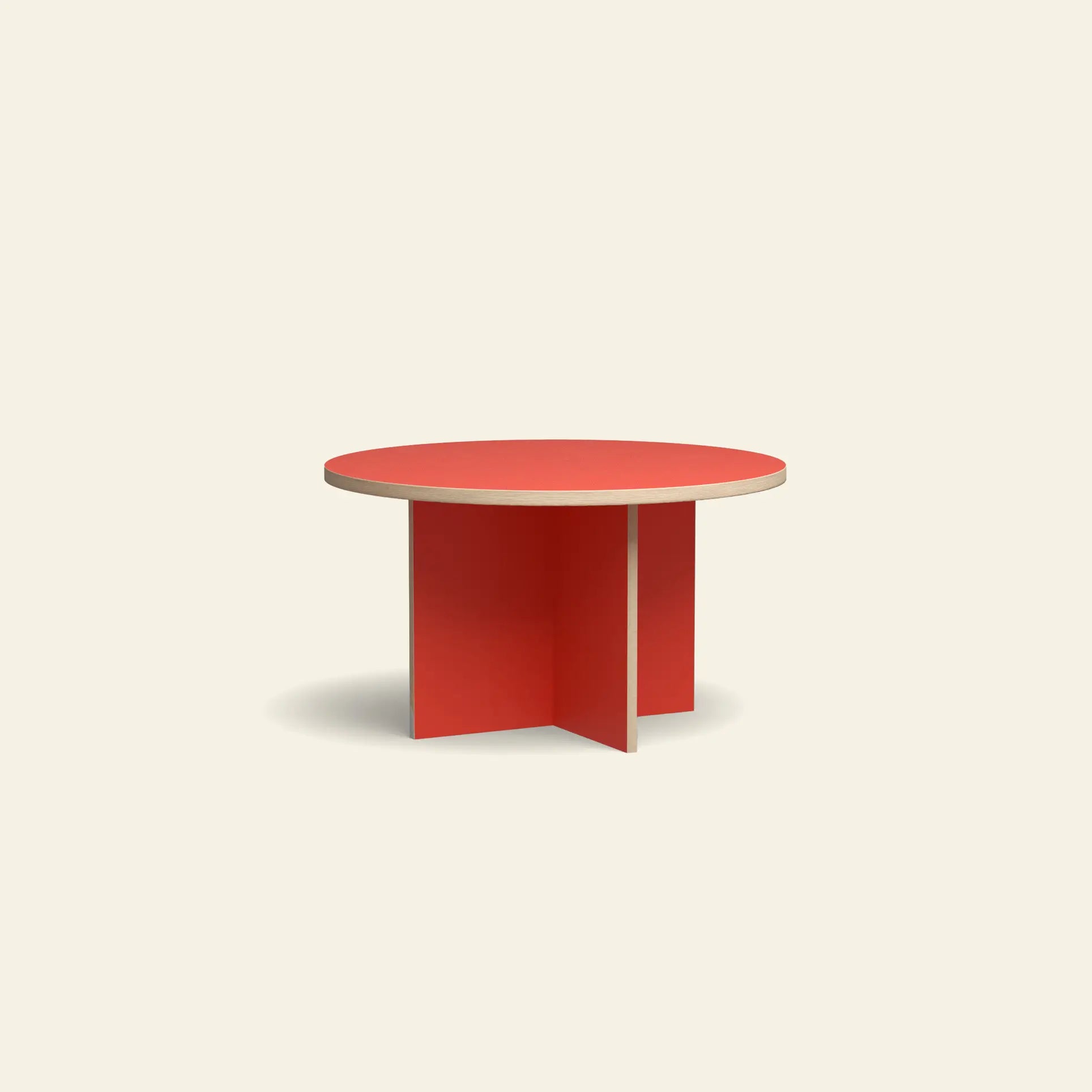 The HKLIVING Dining Table, Round, 130cm features a striking red top and intersecting red flat panel legs, making it a bold centerpiece against any light beige background.