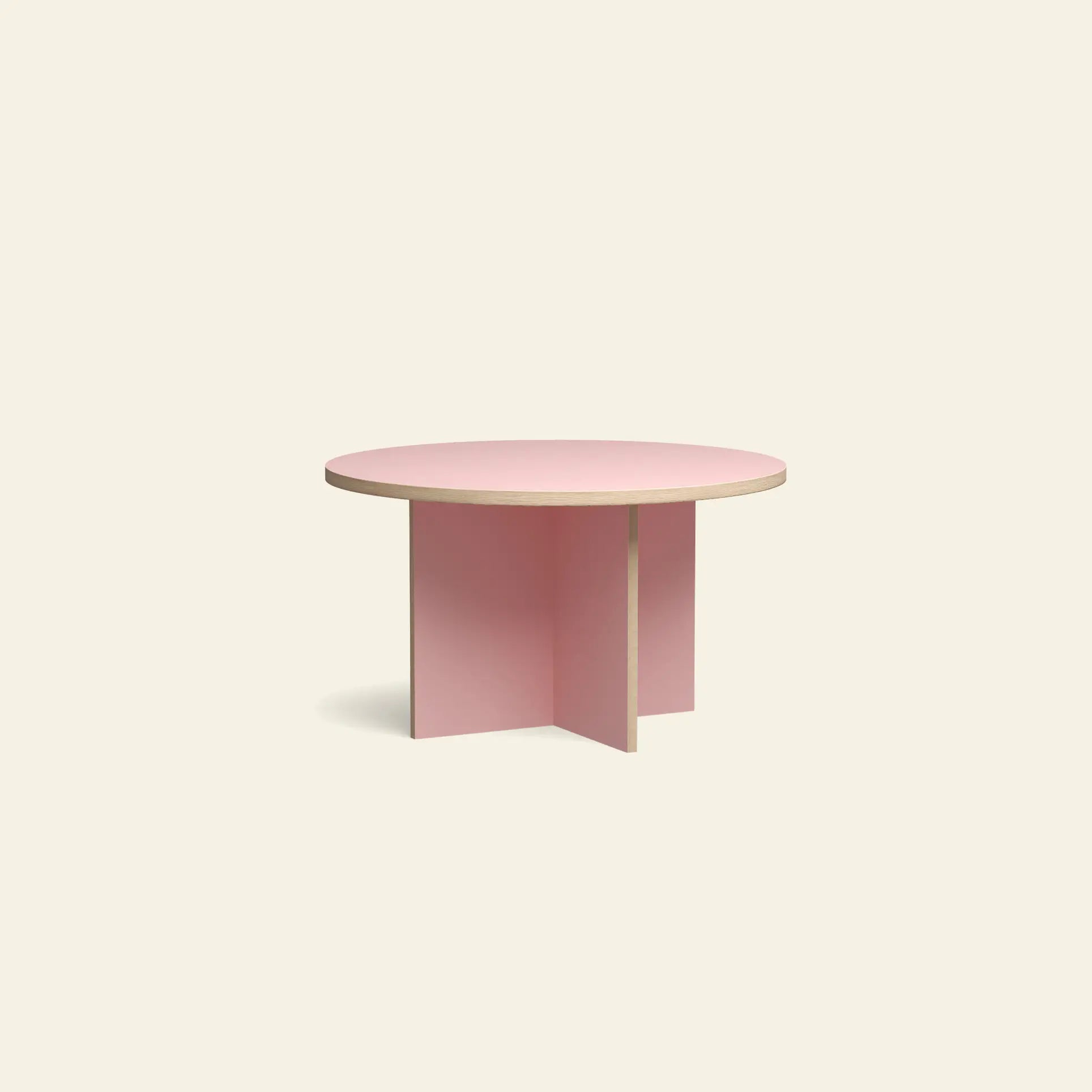 A round coffee table with a light wood top and light pink cross-shaped base, inspired by the HKLIVING Dining Table, Round, 130cm, from HKLIVING, set against a plain off-white background.