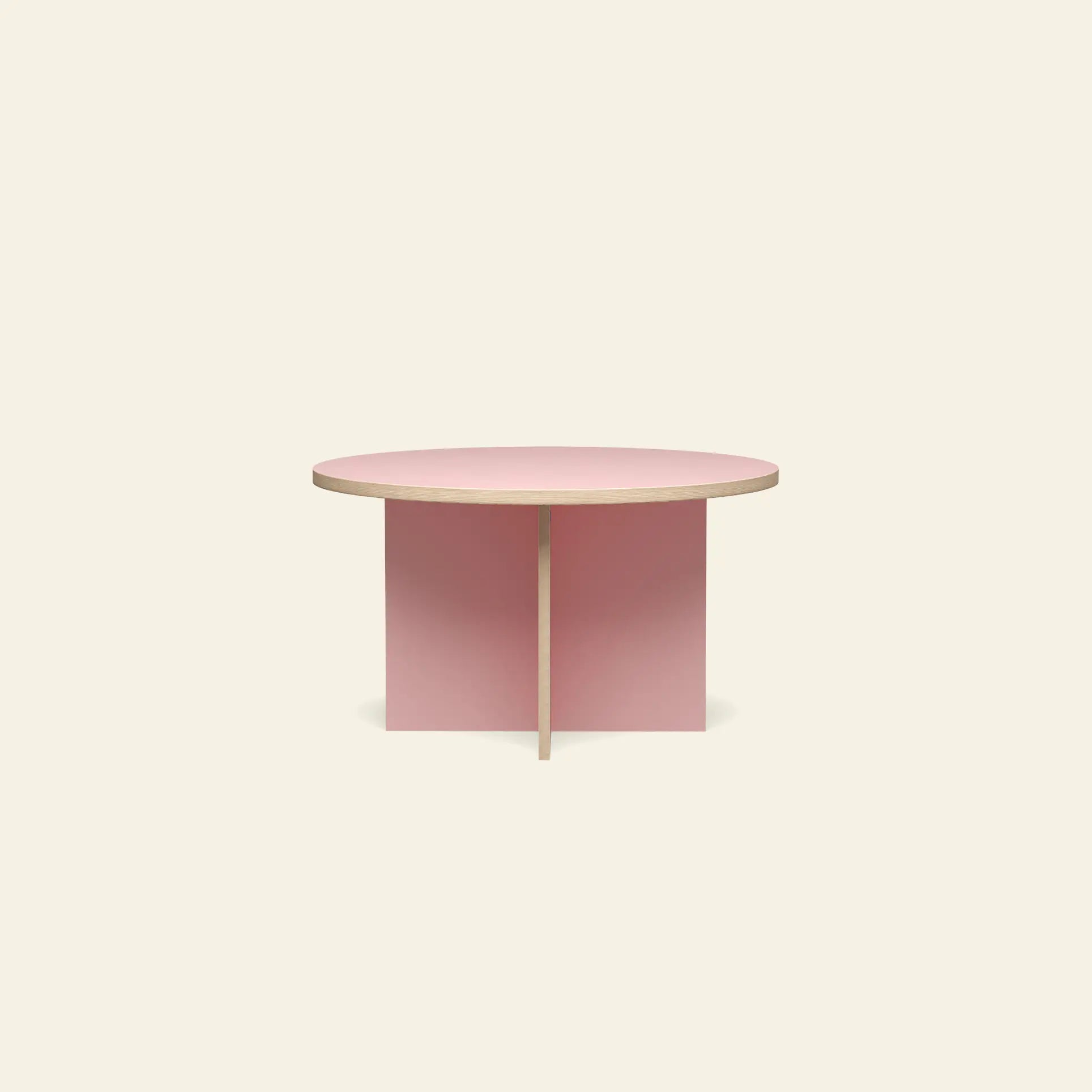 The HKLIVING Dining Table is a modern, round 130cm table with a light pink top and intersecting pink panel legs by HKLIVING, shown against a plain beige background.