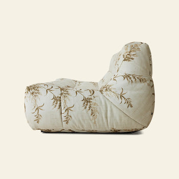 A side view of the HKLIVING Lazy Lounge Bench, a cushioned chair by HKLIVING, with cream fabric and a brown botanical pattern—ideal for stylish lounge seating against a plain, light background.