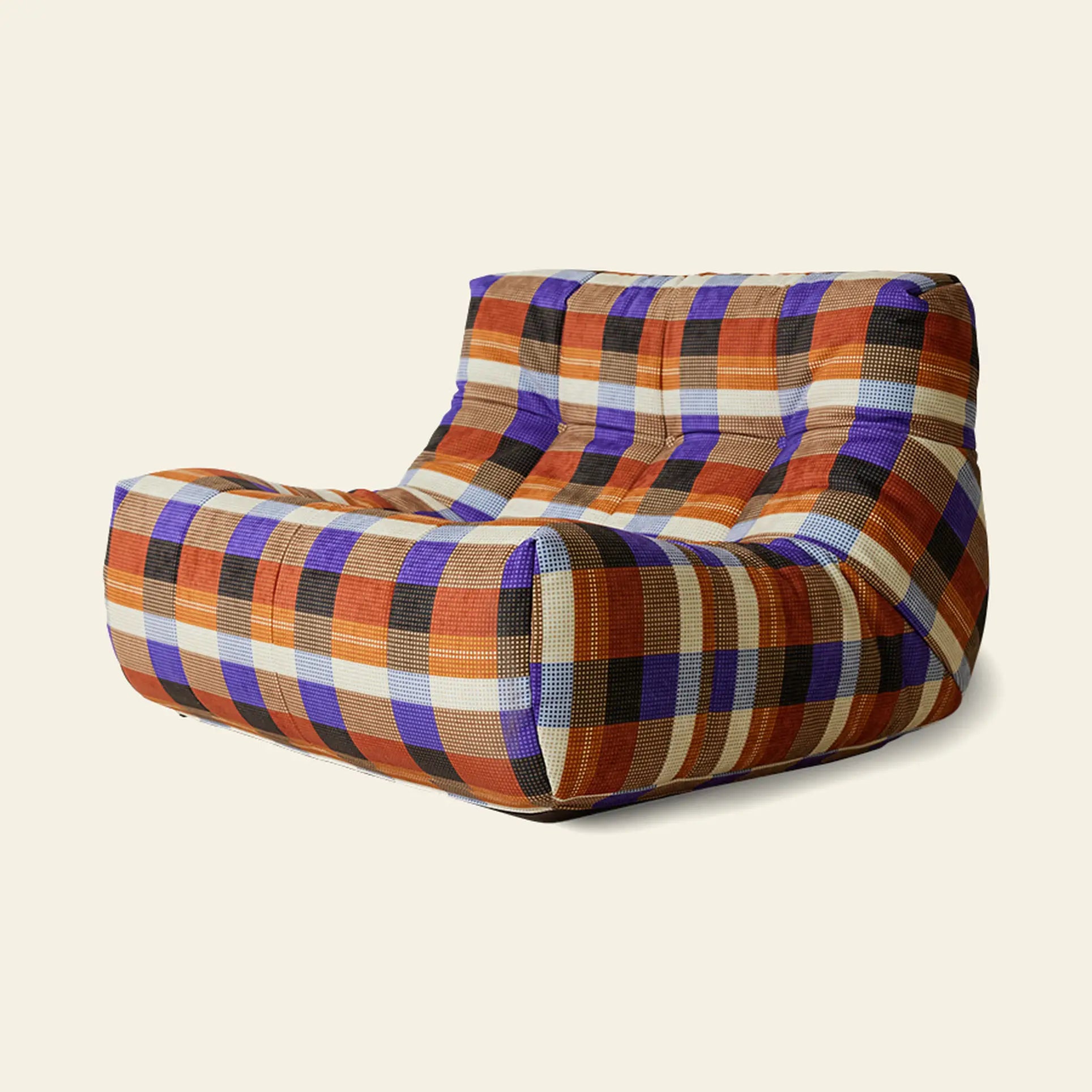The HKLIVING Lazy Lounge Chair by HKLIVING features thick cushions and modern, low-profile design, upholstered in playful bold orange, purple, black, and beige plaid squares on an off-white background.