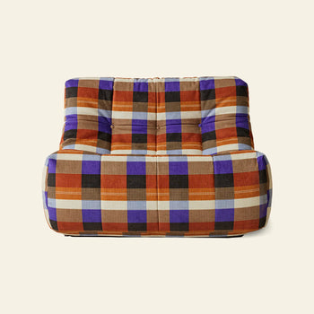The HKLIVING Lazy Lounge Chair by HKLIVING features bold, colorful plaid upholstery in orange, purple, black, and beige squares—adding playful prints to any space with its modern armless design and off-white background.