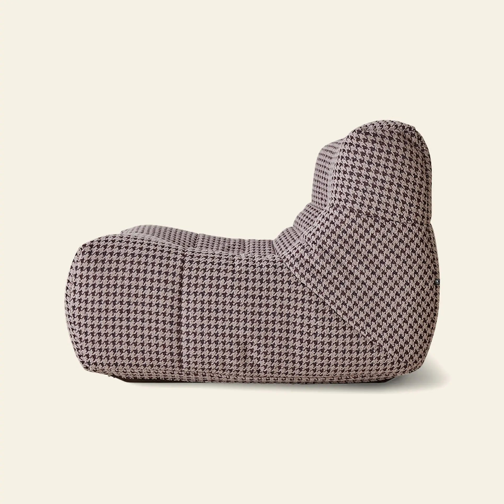 The HKLIVING Lazy Lounge Chair by HKLIVING features a modern, low-profile silhouette with soft curves and brown-and-beige houndstooth upholstery, shown side-on against a plain light background.