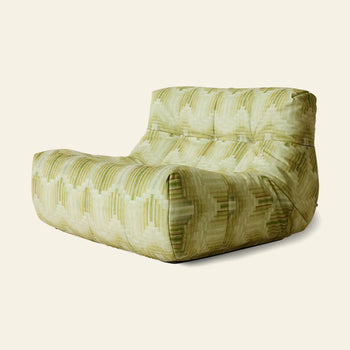 The HKLIVING Lazy Lounge Chair by HKLIVING features a modern, low-profile design with a tufted backrest and seat, upholstered in textured light green fabric with playful prints and geometric patterns for a relaxed, inviting vibe.