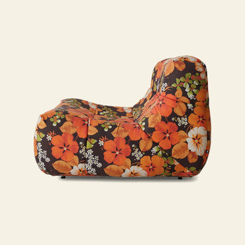 The HKLIVING Lazy Lounge Chair Outdoor by HKLIVING features a bold floral pattern with large orange, red, and white flowers and green leaves, shown from the side against a light beige background.