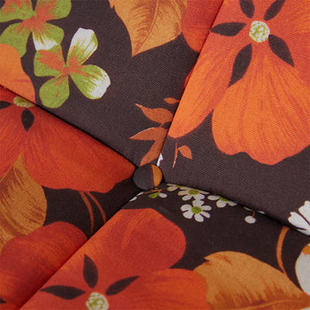 Close-up of the HKLIVING Lazy Lounge Chair Outdoor by HKLIVING, showcasing cozy fabric upholstery with a bold orange, green, and white floral pattern on a dark background. A tufted center with a covered button adds texture and plush comfort.