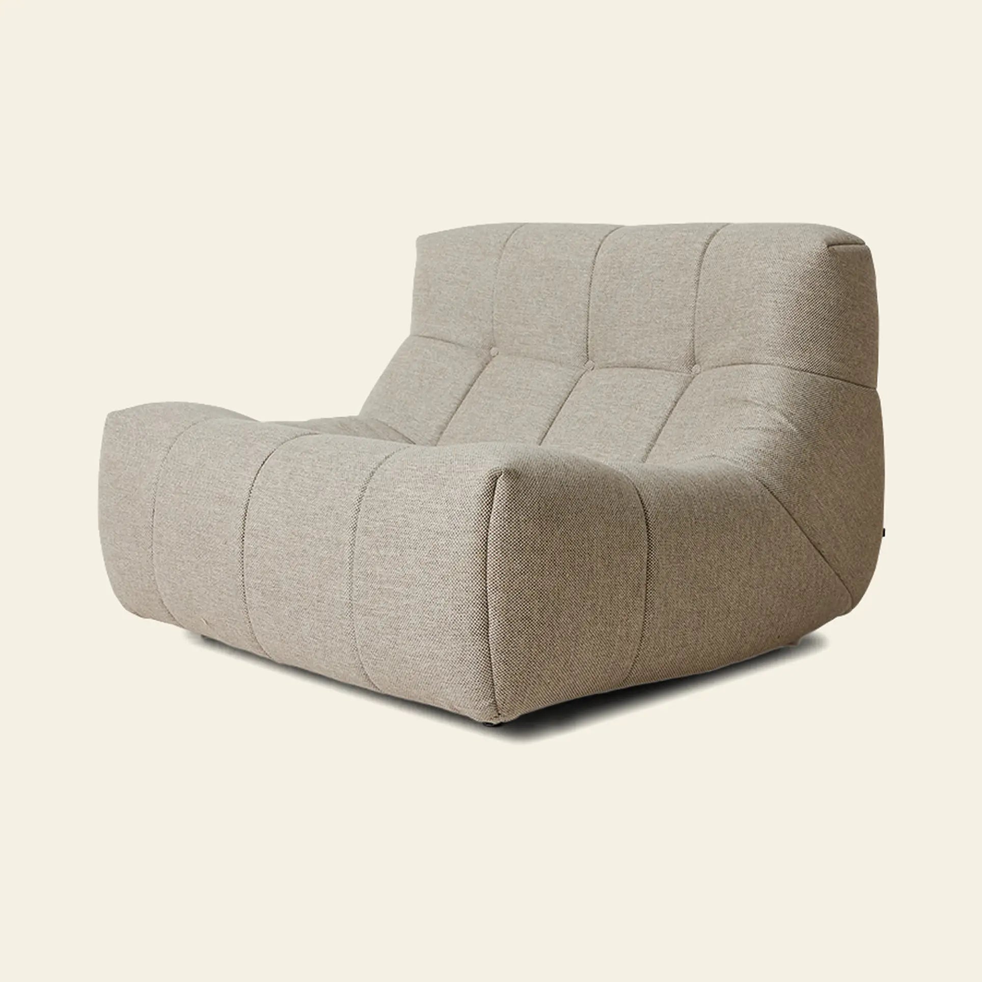 The HKLIVING Lazy Lounge Chair Outdoor by HKLIVING is a modern, beige, armless lounge chair with plush tufted seating and a low, wide design, shown against a plain light background.