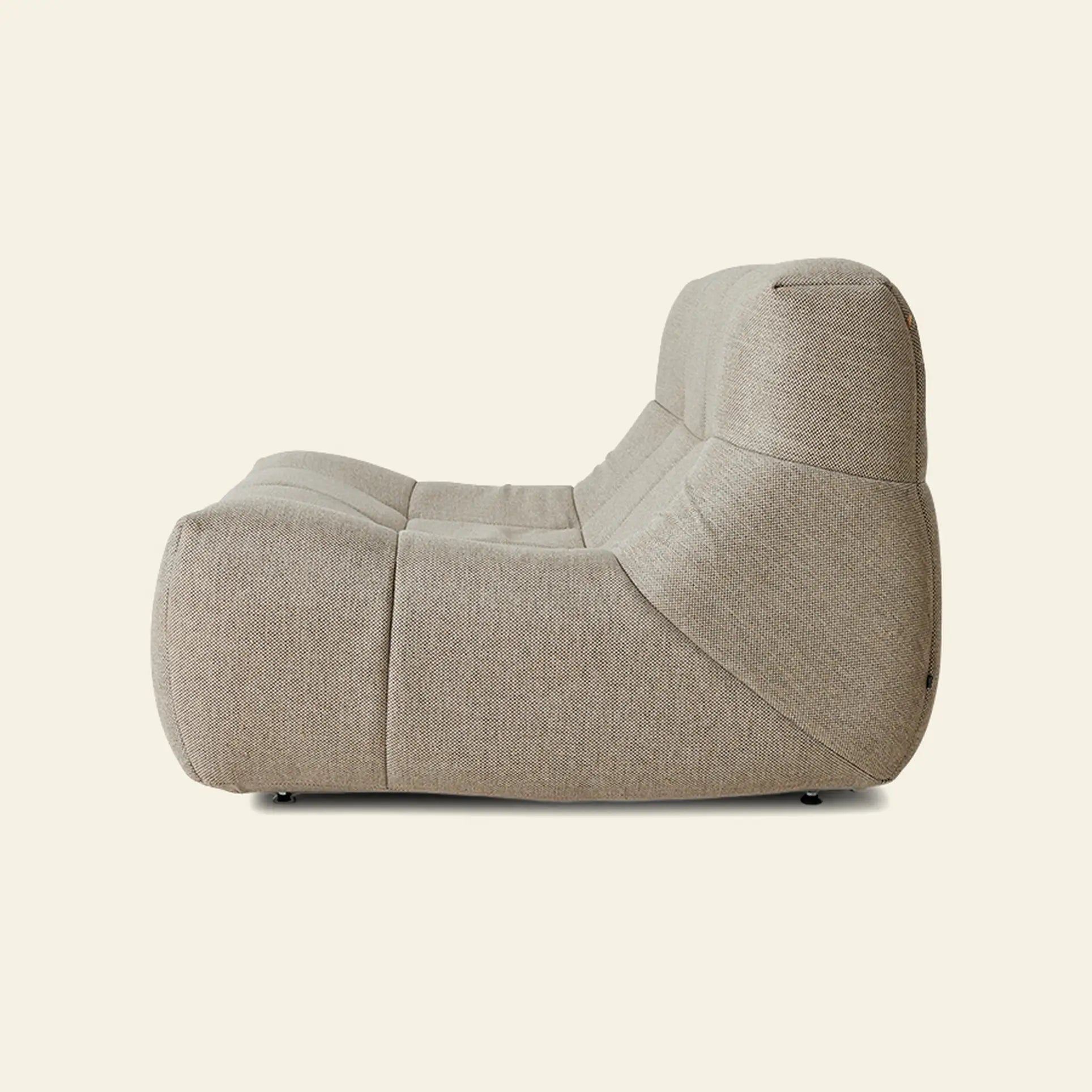The HKLIVING Lazy Lounge Chair Outdoor by HKLIVING features a modern beige design with plush, soft curves. Shown from the side against a plain light background, it offers inviting comfort like a cozy lounge chair.
