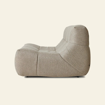 The HKLIVING Lazy Lounge Chair Outdoor by HKLIVING features a modern beige design with plush, soft curves. Shown from the side against a plain light background, it offers inviting comfort like a cozy lounge chair.