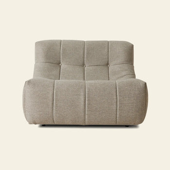 The HKLIVING Lazy Lounge Chair Outdoor by HKLIVING is a modern, armless lounge chair with tufted square sections and textured beige upholstery, featuring a low and wide seat set against a plain light background.