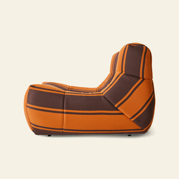 The HKLIVING Lazy Lounge Chair Outdoor by HKLIVING is a modern, lightweight armless lounge chair upholstered in orange and brown striped fabric, shown in profile against a plain light background.