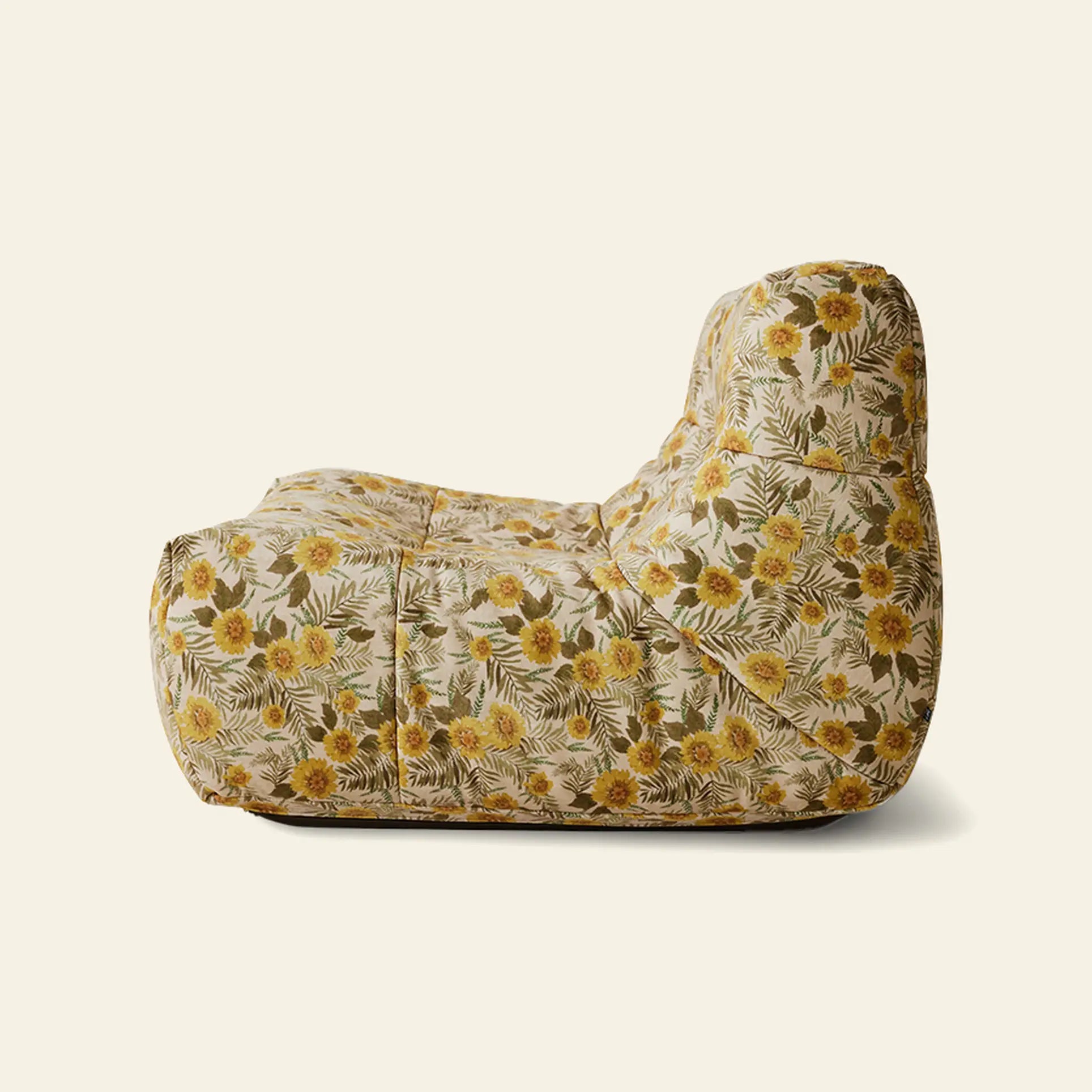 A side view of the HKLIVING Lazy Lounge Chair by HKLIVING, an armless modern lounge chair with a soft, cushioned form and fabric upholstery showcasing playful yellow florals and green leaves on a light background.