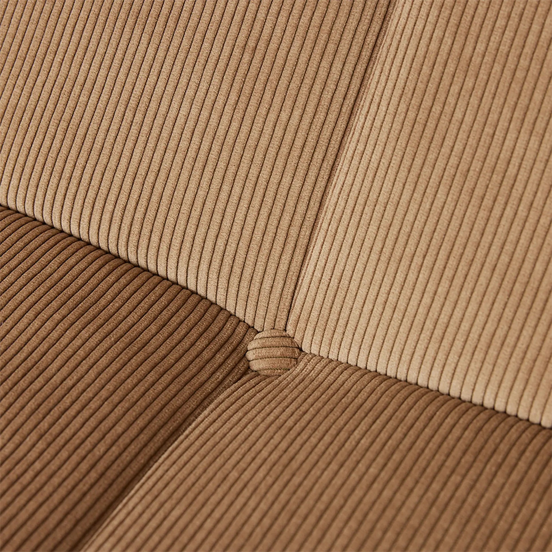 Close-up of the HKLIVING Lounge Bench Corduroy cushion by HKLIVING, featuring vertical ridges, intersecting center seams with a round button, and two brown shades in a quadrant pattern for added comfort and style.