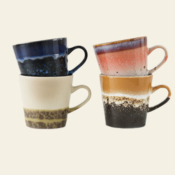 HKLIVING 70s Ceramics: Americano Mugs, Set of 4, features four hand-glazed stoneware mugs in blue, pink, beige, and brown with unique speckled finishes stacked in two uneven piles against a light background.