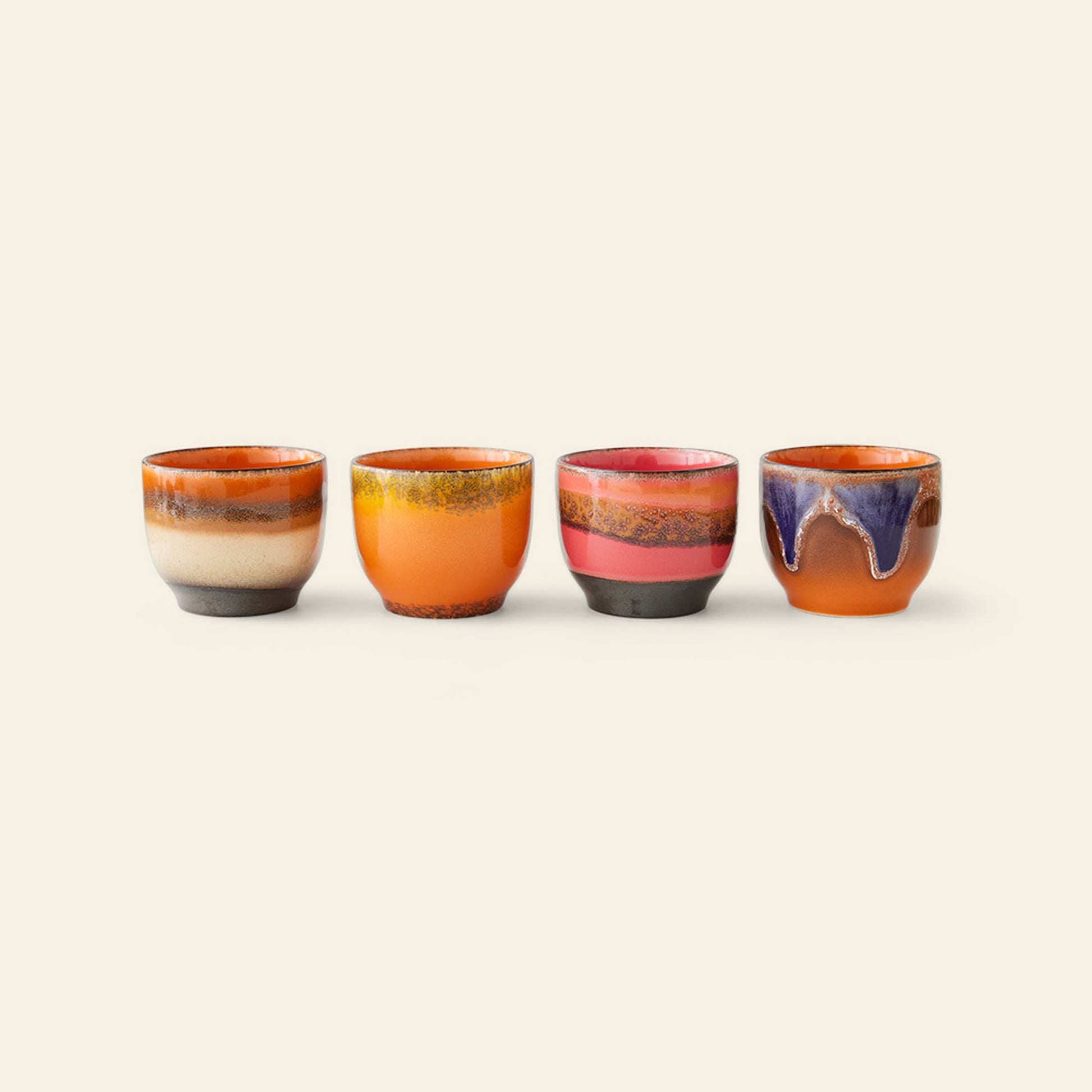 The HKliving 70s Ceramics: Café Cups, Set of 4 - Java by HKliving features retro cups with unique, colorful glazes in warm orange, pink, purple, and brown tones arranged on a light background.