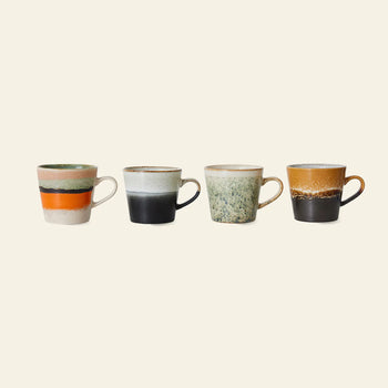 The HKLIVING 70s Ceramics: Cappuccino Mugs, Set of 4 features uniquely hand-glazed mugs with handles in retro stripes, speckles, and earthy tones, capturing vintage charm against a light backdrop.