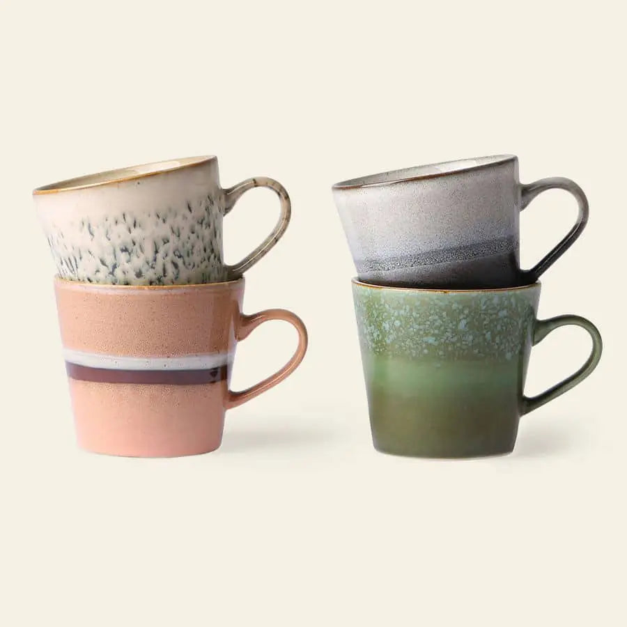 The HKLIVING 70s Ceramics Cappuccino Mugs, Set of 4, features hand-glazed ceramic mugs in pink, green, beige, and gray with textured and gradient designs inspired by retro patterns.