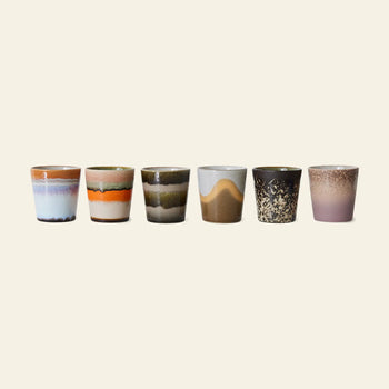 The HKLIVING 70s Ceramics Coffee Mugs Set of 6 features expertly handcrafted mugs, each with unique colors and patterns—wavy stripes, speckles, and gradients—inspired by vintage style, all set against a plain light background.