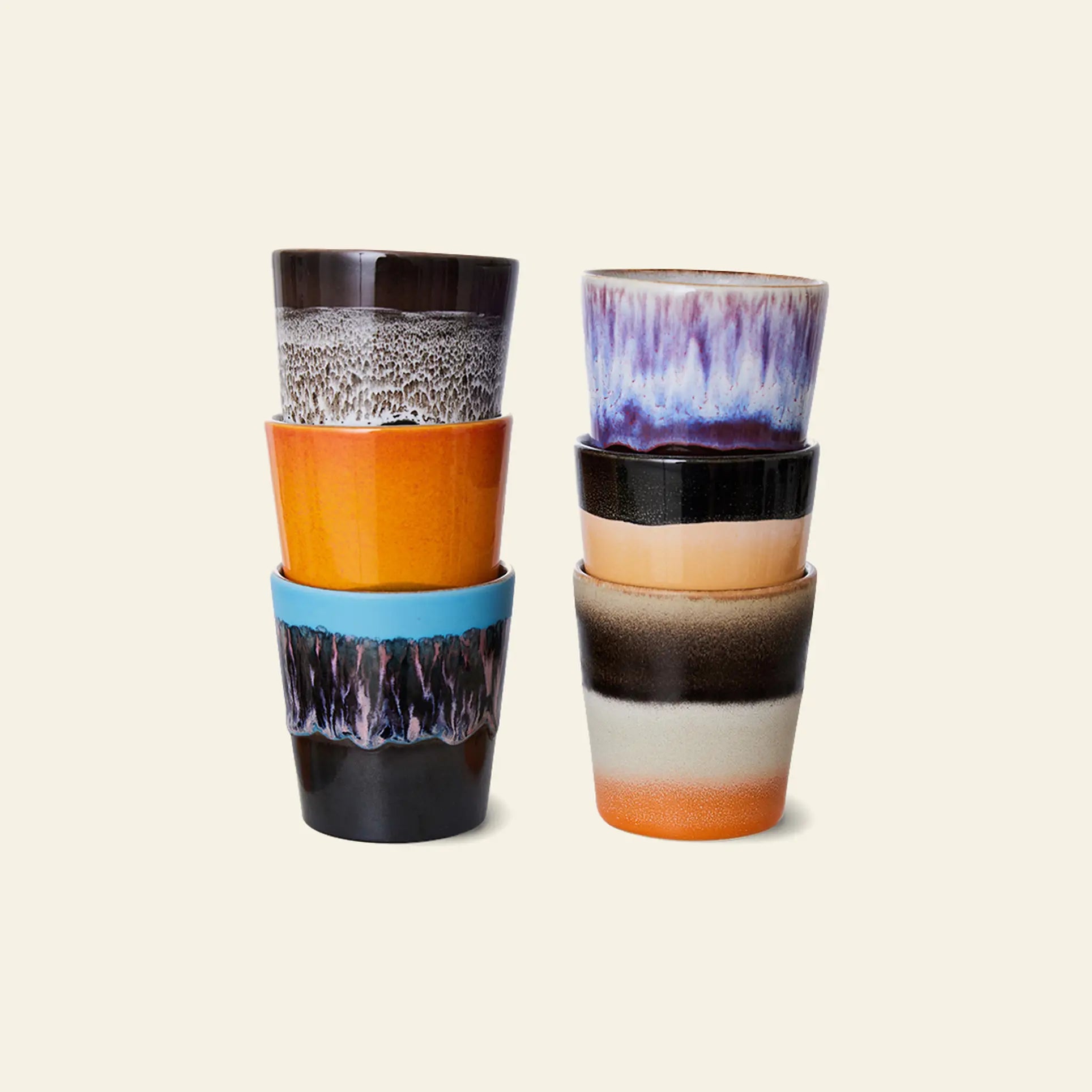 The HKLIVING 70s Ceramics: Coffee Mugs, Set of 6 features colorful, uniquely glazed mugs inspired by classic 70s designs. Stacked in two columns of three, they stand out against a plain light beige background.