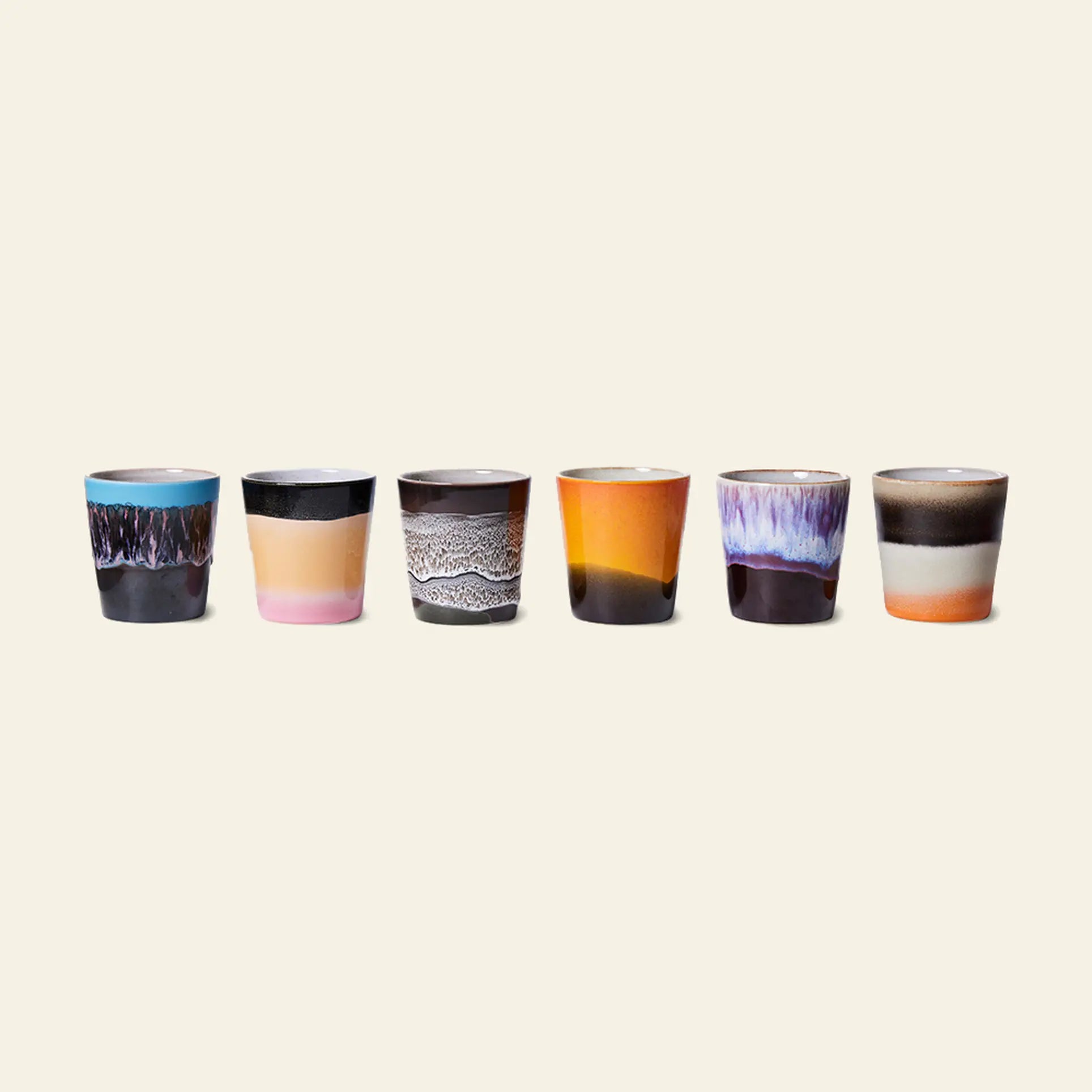 The HKLIVING 70s Ceramics Coffee Mugs Set of 6 showcases mugs with unique, colorful handcrafted glazes in blue, pink, brown, orange, and white, arranged in a row against a light background.