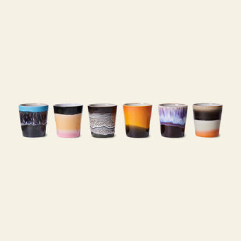 The HKLIVING 70s Ceramics Coffee Mugs Set of 6 showcases mugs with unique, colorful handcrafted glazes in blue, pink, brown, orange, and white, arranged in a row against a light background.